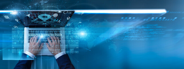 Analyst using laptop with GIS software on keyboard and analyzing spatial mapping data, satellite images, location intelligence, environmental research, and geographic information systems. © CyberFrame