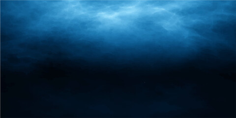 Obraz premium A dark blue sky with rays of light shines over a deep stormy ocean wave beneath cloudy night backgrounds