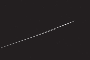 Realistic shooting star leaving vector background. A thin white trail line across the solid black starfield.  © PanzaDesign