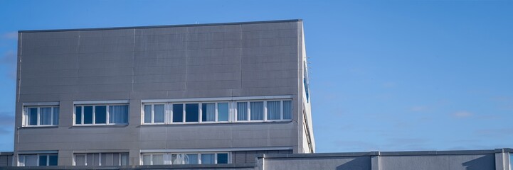 Fototapeta premium Modern building facades under clear blue sky