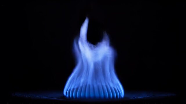 Blue gas flame igniting and burning with elegant curves against a dark background, showcasing the beauty of combustion and energy