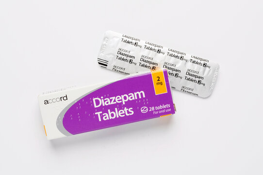 Diazepam Tablets 2mg packaging with foil blister pack top view on white. Diazepam, often sold under the brand name Valium, is a benzodiazepine used to treat anxiety, muscle spasms, seizures,