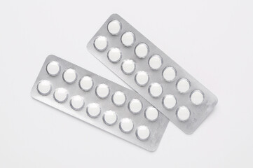 Foil Blister packs containing pills medication on white background with copy space