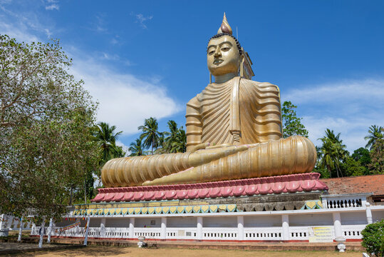 DIKWELLA, SRI LANKA - FEBRUARY 17, 2020: Giant sculpture of a seated Buddha in the Wewurukannala Vihara buddhist temple