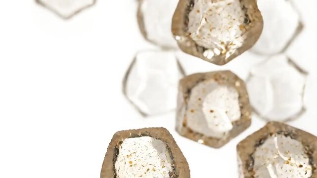 Several cut geodes are scattered on a white surface for display purposes.