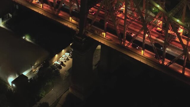 View of traffic on bridge and waterfront area in New York at night