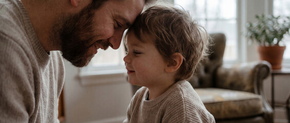Obraz premium Father and young son sharing happiness on Family Day in a cozy living room