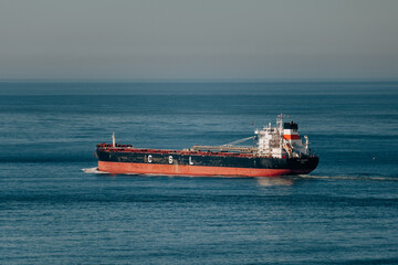 Large Cargo Vessel Moving Steadily Through Calm Waters Symbolizing Worldwide Logistics And Shipping Operations