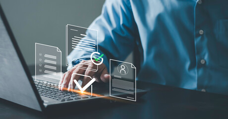 Audit, document verification, compliance review, and quality control process. Businessman using laptop check digital document with signature and checkmark icons. © Krittamet