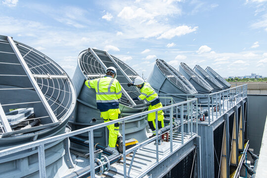 Professional Worker Teamwork Servicing HVAC building cooling tower, Industry air conditioner service