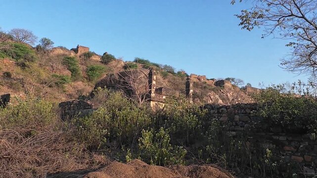 The abandoned and neglected ruins of the 15th-century Indore Fort located on a rocky ridge in the Mewat region of Haryana, India