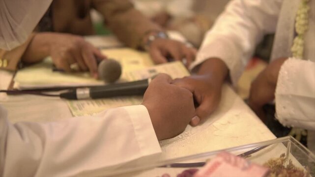 4K Close up of a groom shaking hands during a traditional Islamic wedding ceremony or Akad Nikah.