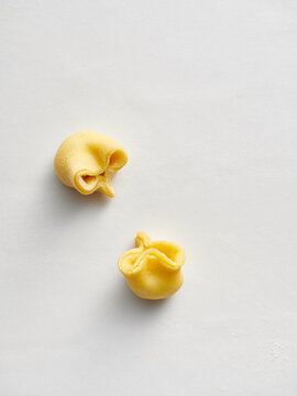 Freshly made pasta dough pockets ready for stuffing. Ideal for restaurant menus, food blogs, and culinary classes focused on Italian cooking