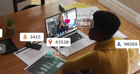 Reviewing woman in mustard sweater studying charts on laptop call with alerts at home, copy space