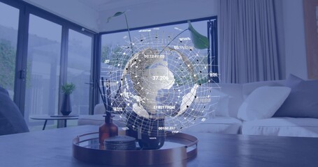 Projecting hologram globe above plant on table in living room, tray with amber bottle and coasters