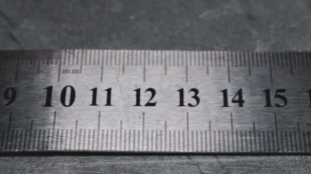 A close-up view of a ruler lying on a flat surface, ready for use