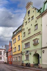 Fototapeta premium Historic street with colorful houses in Old Town of Riga, Latvia. Beautiful green facade and traditional medieval architecture