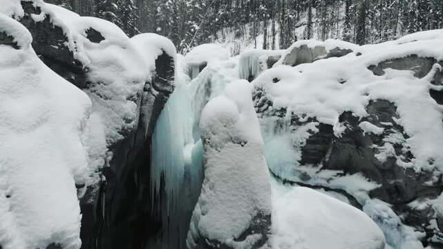Aerial drone view of frozen Athabasca Falls canyon in winter, Jasper National Park Alberta Canada