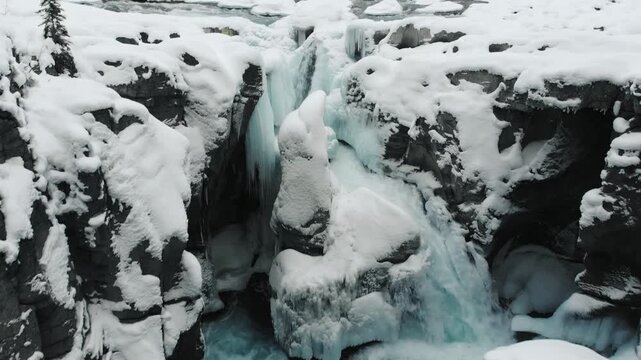 Aerial drone view of frozen Athabasca Falls canyon in winter, Jasper National Park Alberta Canada