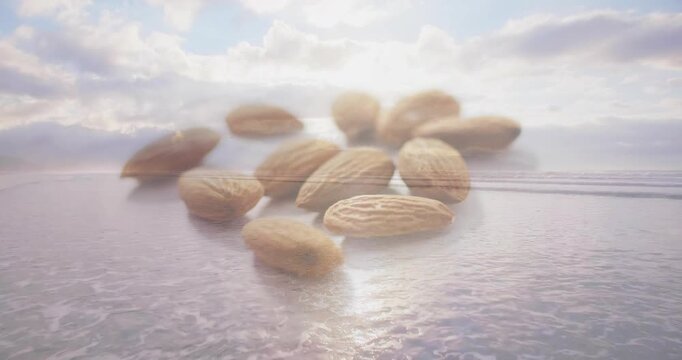 Almond cluster appearing frame 1 over shoreline, floating, drifting with light, creating soft glow