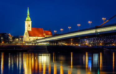 Fototapeta premium Bratislava night skyline with St Martins Cathedral bridge and reflections