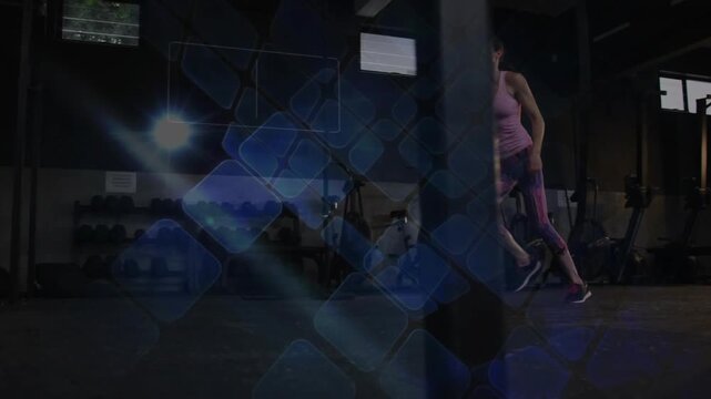 Woman trainer rising from crouch, doing lateral drills for fitness, blue overlay tracing steps