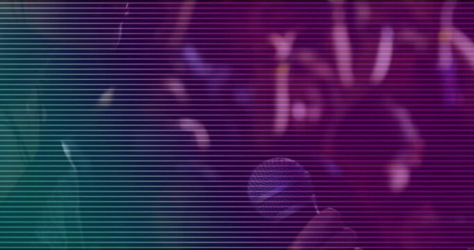 Right hand entering right side, holding round patterned object moving inward to catch colored light