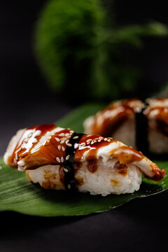 Delicious teriyaki nigiri sushi with sesame seeds on leaf
