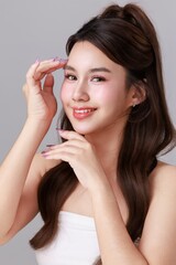 Obraz premium Young Asian Beauty Woman with Long Hair and Natural Makeup Healthy Skin Skincare Concept on Clean Studio Background.