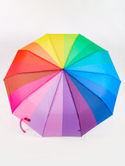 Multicolored umbrella on a white background. The colors of the LGBT community.