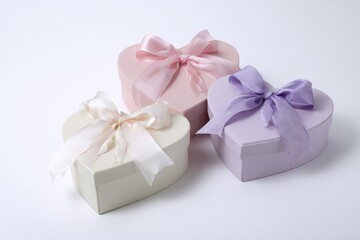 Fototapeta premium Romantic pastel flat lay featuring heart-shaped boxes in blush and lavender tones.