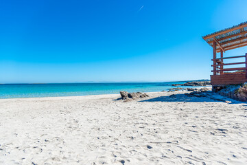 Fototapeta premium Wooden porch by the sea in Sardinia on a sunny morning