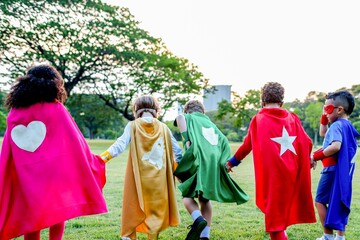 Fototapeta premium Children wearing colorful superhero capes