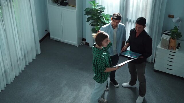 Caucasian business woman walking and presenting business plan by using financial graph to smart team while standing at meeting room. Investor talking and discuss about marketing strategy. Convocation.