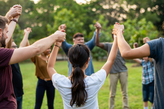 Diverse group holding hands outdoors