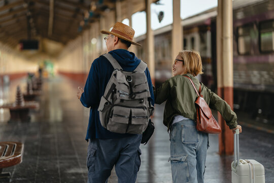 Mature couple waiting at train station for travel experience