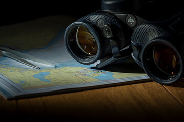 Binoculars on nautical chart with compass and rope maritime adventure still life © Leonard