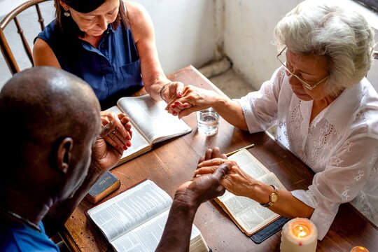 Diverse group praying together.
