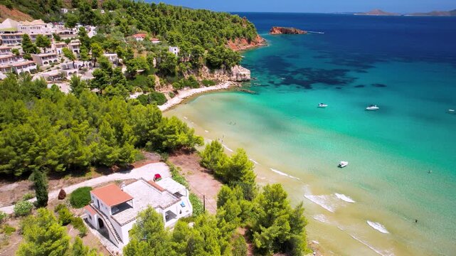 Alonissos Greece 4k aerial drone video of Chrysi Milia beach with turquoise shallow waters. Luxury yacht anchored in beautiful bay with golden sand. Exotic Sporades islands travel destination