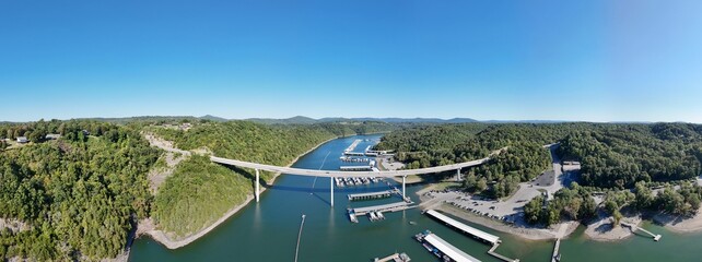 Aerial View of the Lakeside Sunset Marina Resort on Dale Hollow Lake With Highway 111 Bridge, Boats and Forested Shoreline, Calm Water on a Sunny Day, Monroe, Tennessee, USA. © Friedrich