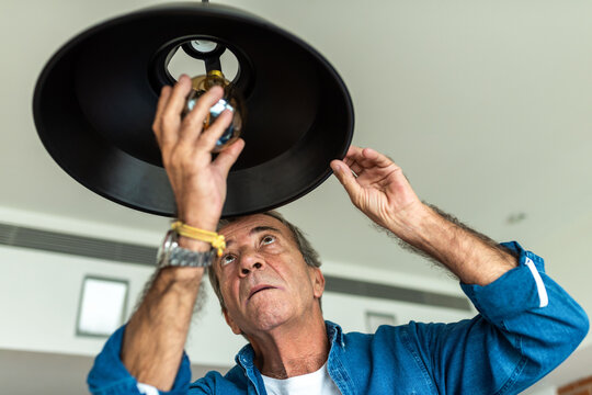 Man changing light bulb.