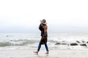Woman strolling serene beach