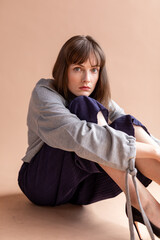 Pensive woman sitting thoughtfully.