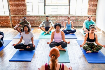 Diverse group practicing yoga indoors.