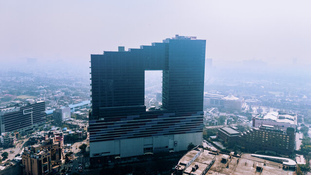 Aerial drone view of Noida city skyline with modern residential towers and urban infrastructure in Delhi NCR, Uttar Pradesh, India.