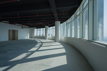 Obraz premium Spacious modern office interior with curved floor-to-ceiling windows and natural light