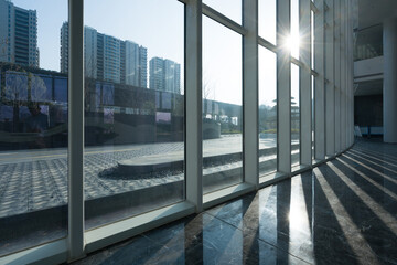 Sunlight streaming through glass curtain wall of modern building interior space © zhu difeng