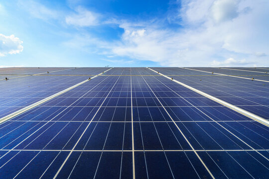 Photovoltaic solar power panel on dramatic sunset blue sky background, green clean Alternative power energy concept.