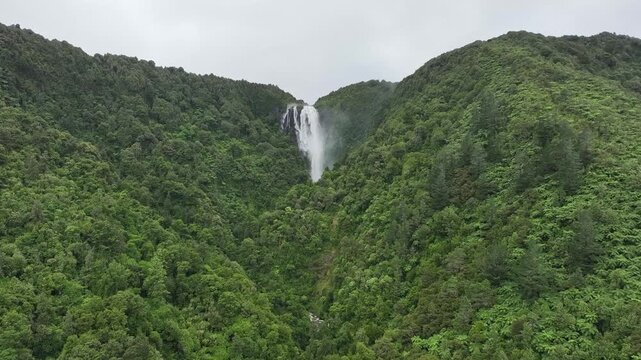 Aerial Wide Shot of a Majesic Waterfall in a Deep Lus Green Forest