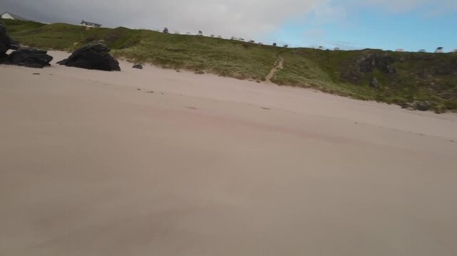 Low Angle FPV Drone Gliding Over Ocean Water Towards andy Beach